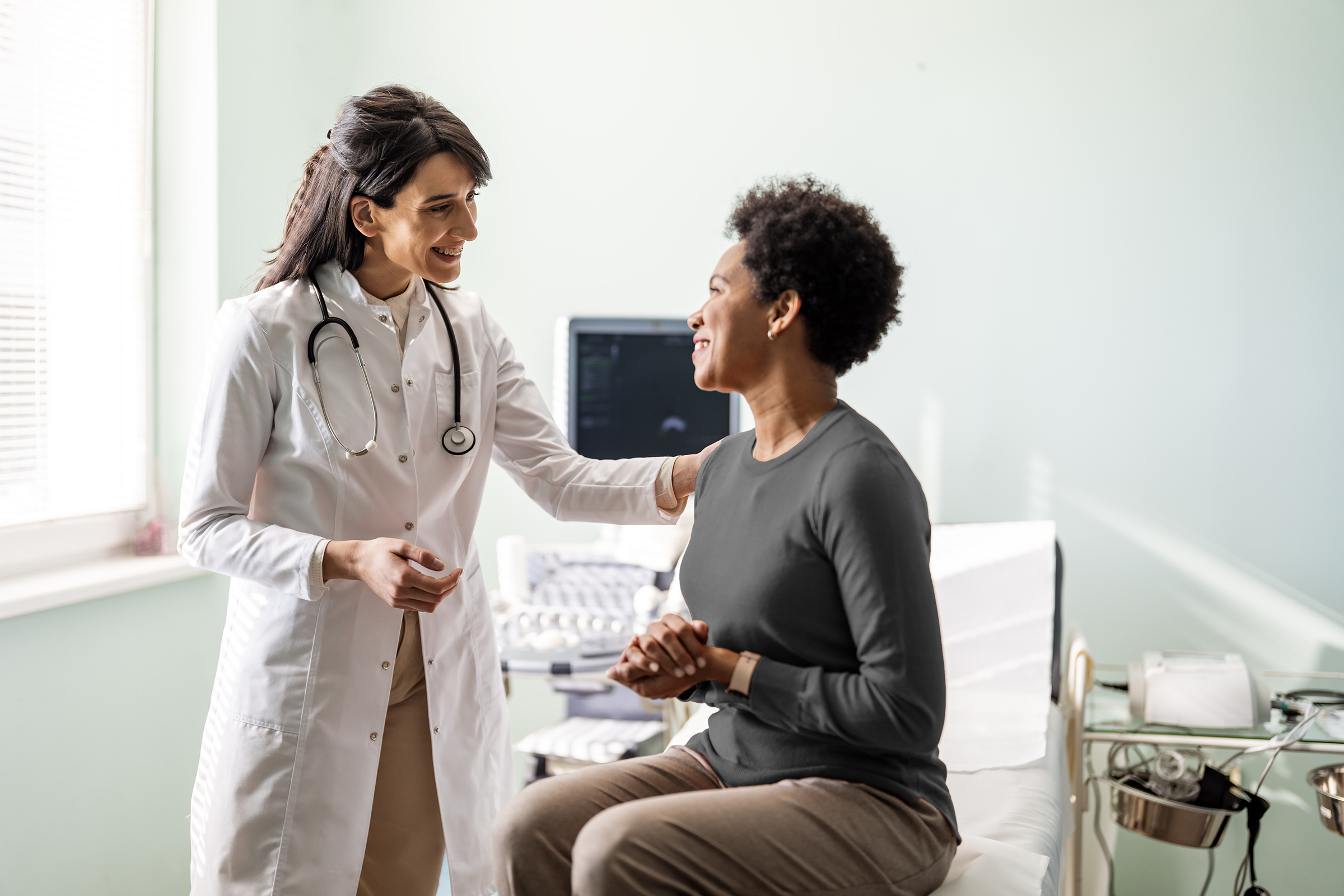 A clinician and business-dressed colleague in a practice.