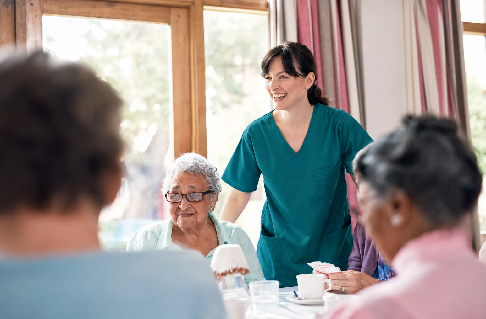A healthcare worker and older adult together.
