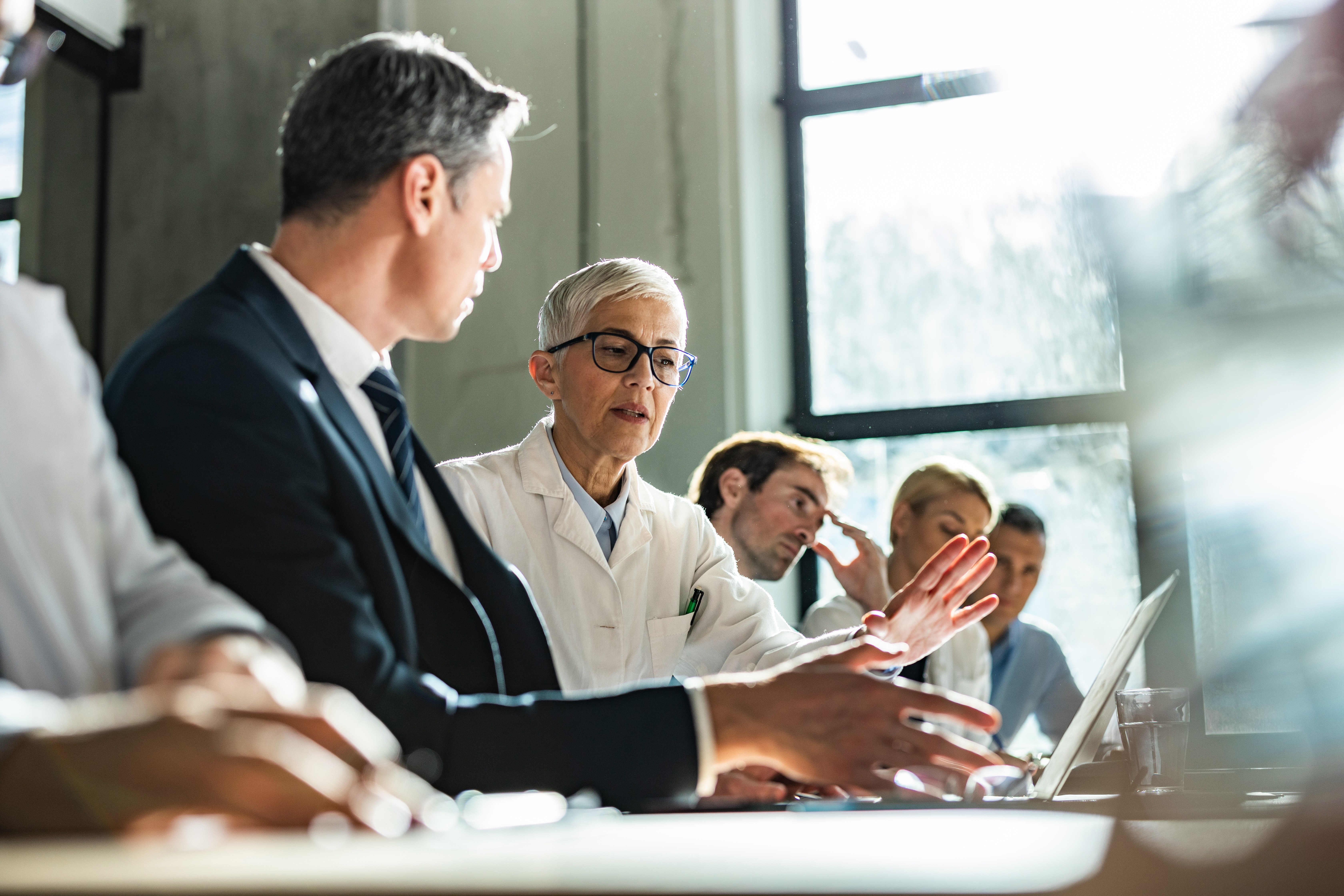 A healthcare professional and colleague reviewing information together.